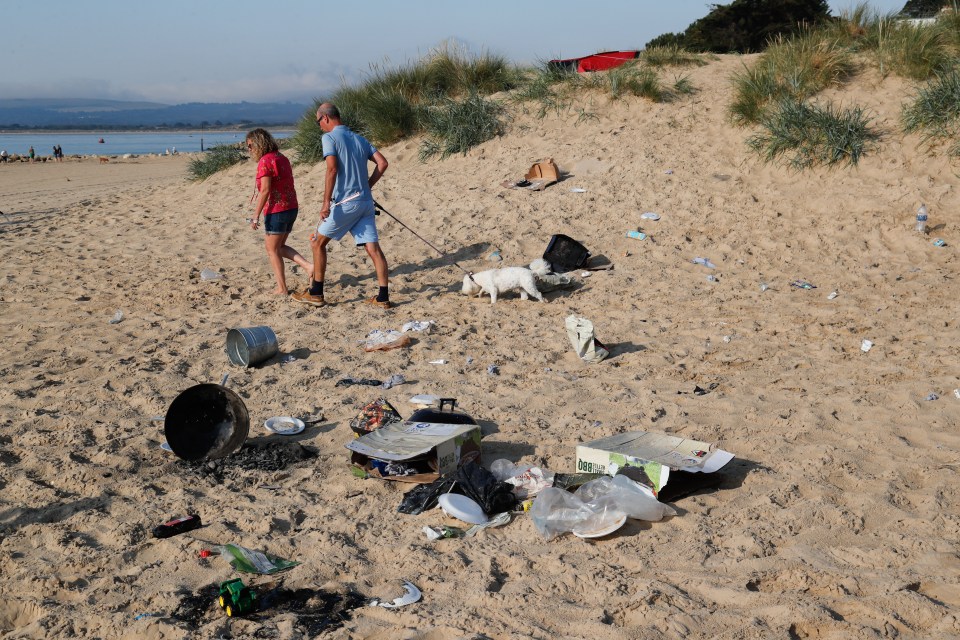 Volunteers are seen clearing rubbish from the beach at Sandbanks, Dorset