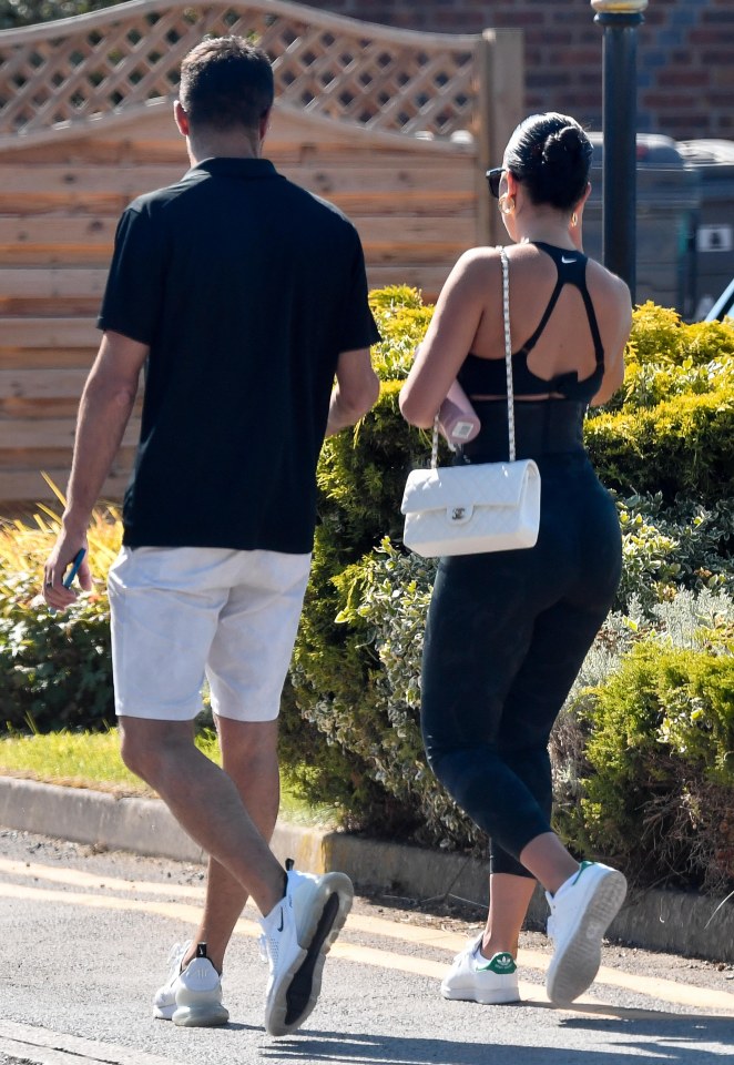 The pair both opted for black tops and white footwear as they strolled to the complex