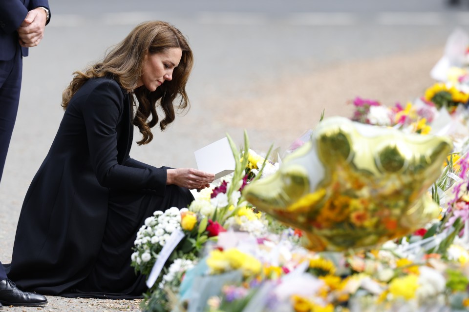 The Princess of Wales reading cards left by the public