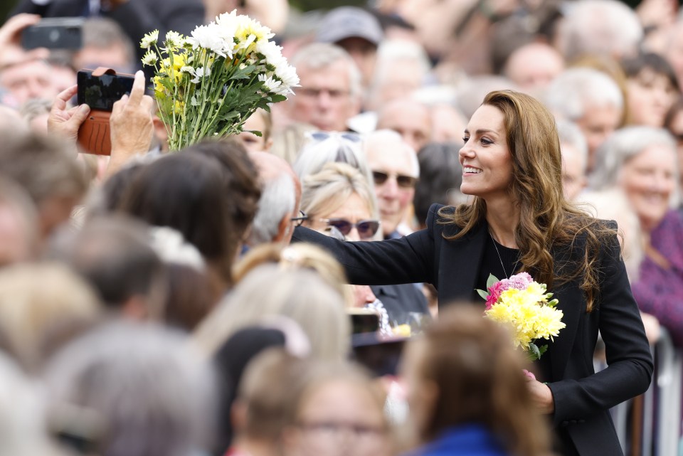 More flowers being given to Kate by members of the public