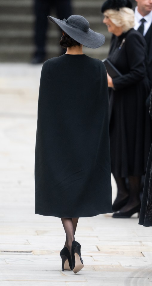 Megan shows her poise on the spindly heels at the Queen's funeral