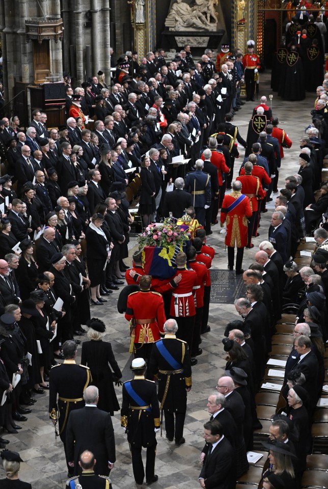 The coffin is carried by the Bearer Party into the church