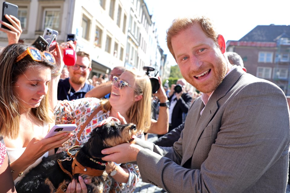 Prince Harry joined her and was greeted by a pet dog