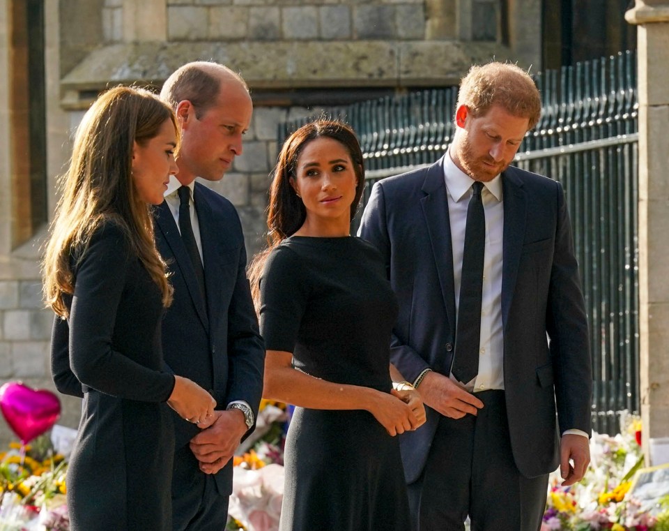 The two couples looked at the floral tributes for the Queen