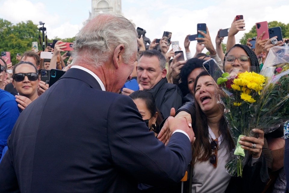 One woman was visibly emotional as the crowd leant in to shake the monarch’s hand