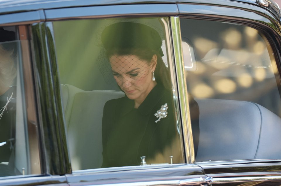 The visibly emotional mum-of-three could be seen wearing a netted hat and pearls as she sat in the back of a chauffeur-driven car