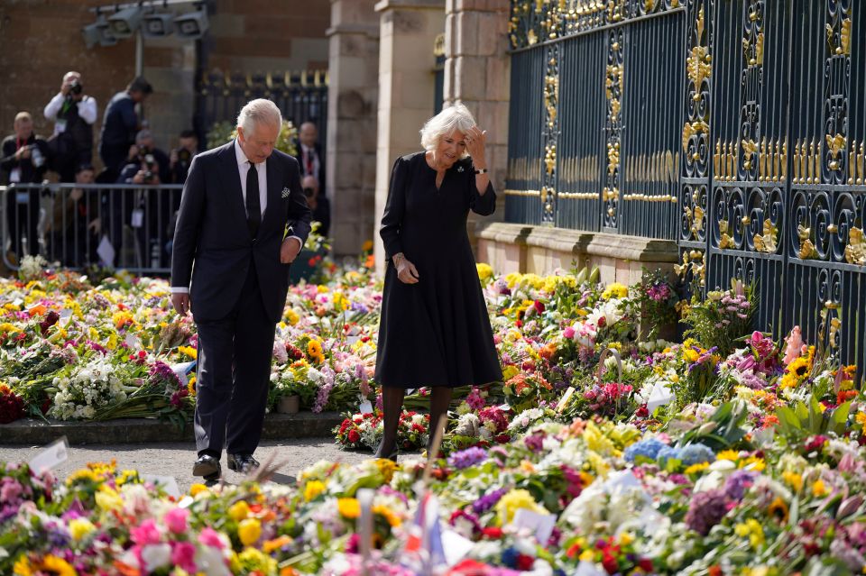 Numerous fans have left flower tributes at royal residences. Pictured are King Charles and Queen Camilla at Hillsborough Castle in Belfast