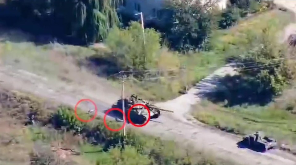 Astonishing footage shows multiple Russian troops falling off a speeding tank in Kharkiv