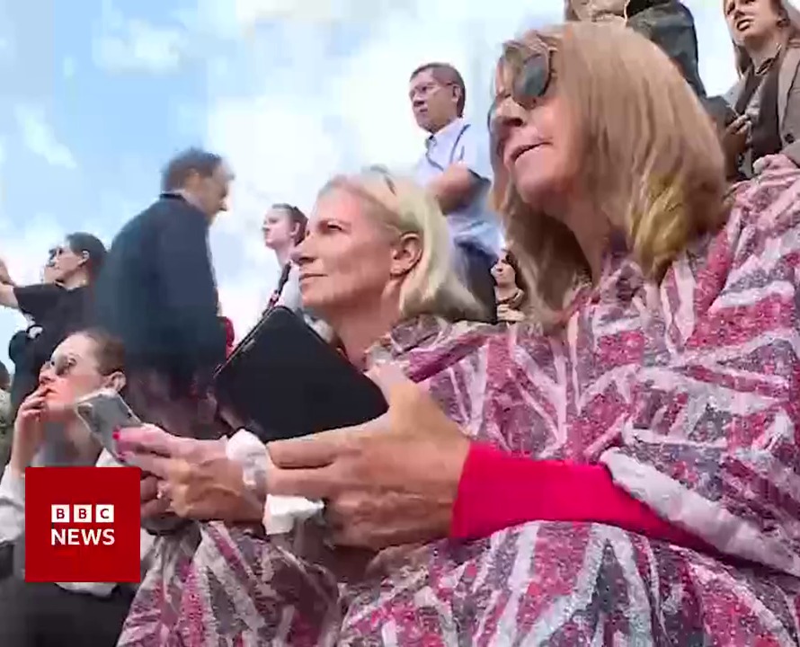 One clip shows well-wishers in Union Flag outfits holding mobile phones