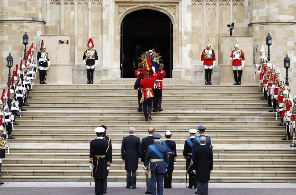 Pallbearers carried the coffin up a huge set of steps to St George's chapel