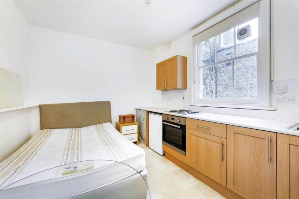 Savills Estate Agents show photographs of studio apartment where resident can access oven from bed.