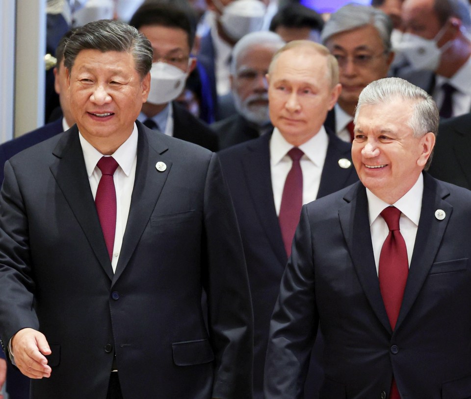 Xi Jinping pictured with Vladimir Putin and Uzbek President Shavkat Mirziyoyev on September 16