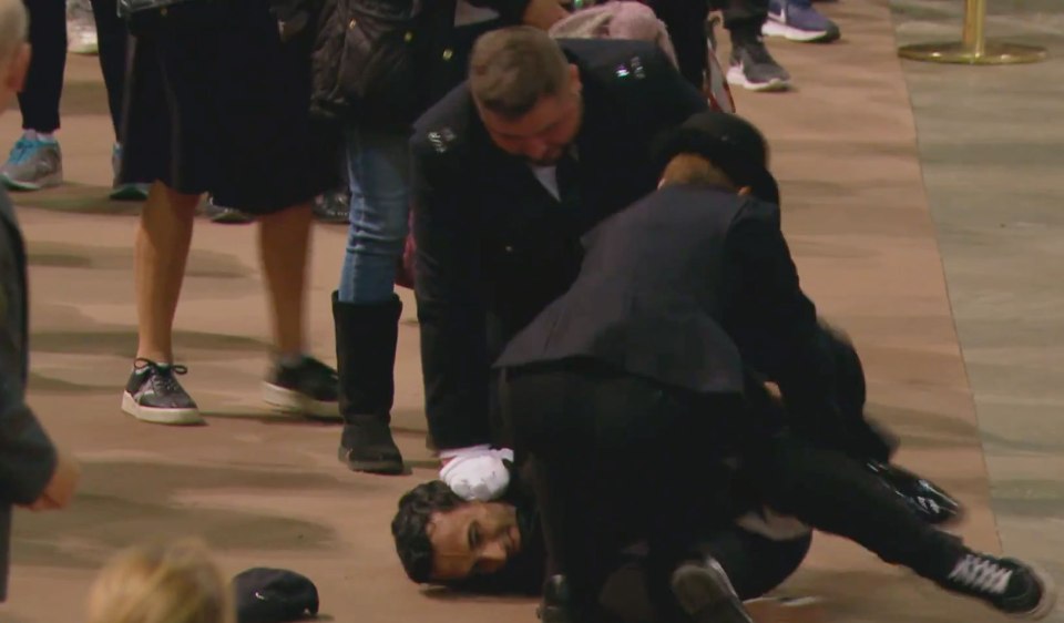 The man was tackled to the ground after trying to grab the flag from the Queen's coffin