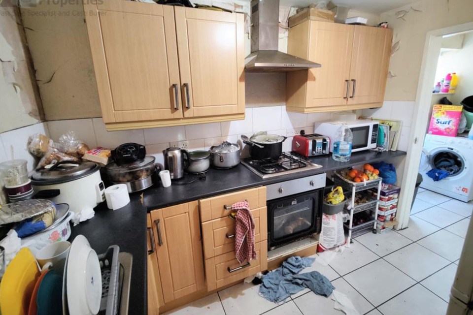 Pots and pans cover every work top and dirty towels are strewn across the floor