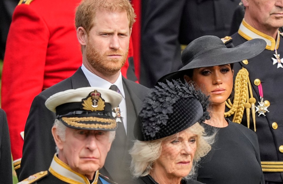 Charles, Camilla, Harry and Meghan watch as the Queen's coffin is placed into the hearse following the state funeral service