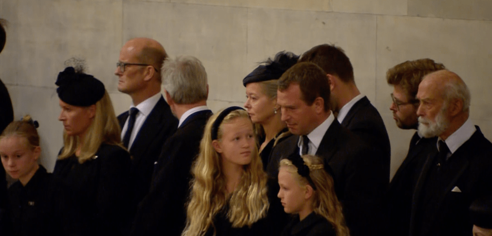 The rarely seen 11-year-old struggled to hide the sorrow on her face as she stood with her relatives