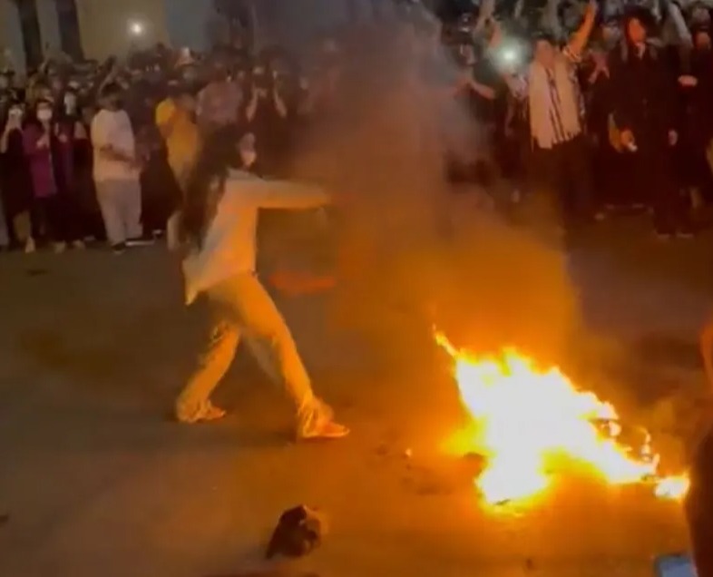 Female protestors have been filmed burning their hijabs