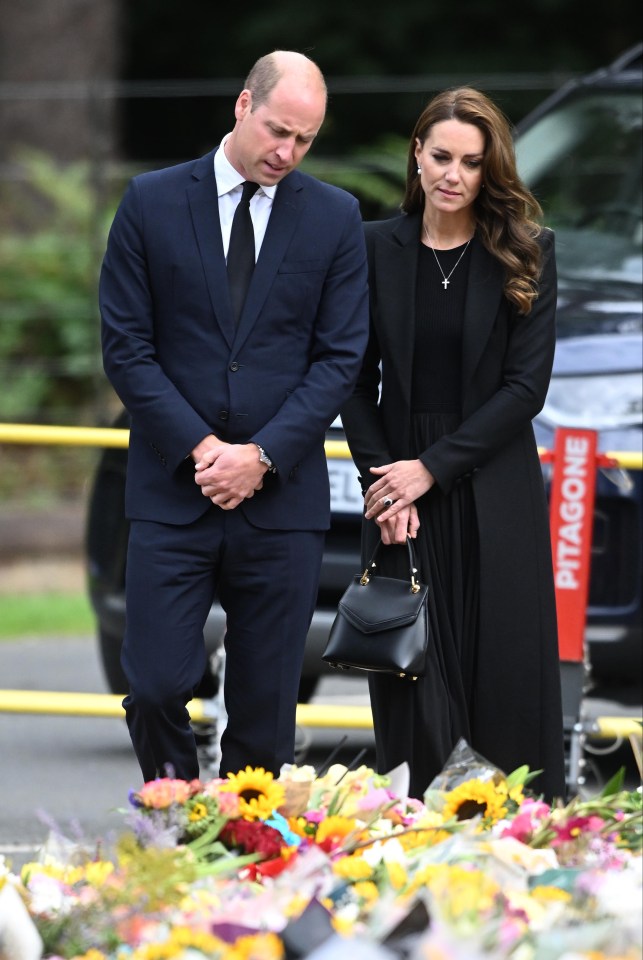 William and Kate appeared emotional as they looked at the sea of flowers left in memory of the late monarch