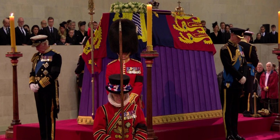 The Queen's children then lowered their heads as they took their places to guard her coffin - before her grandchildren did the same this evening