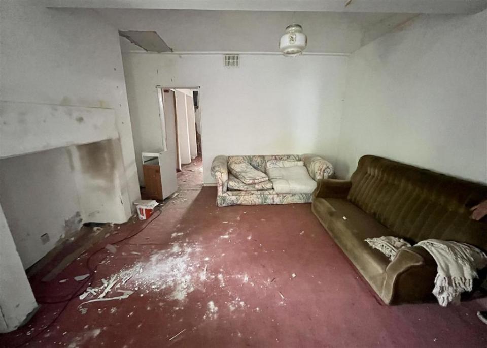 Plaster has been left on the carpet and the walls have dark stains everywhere