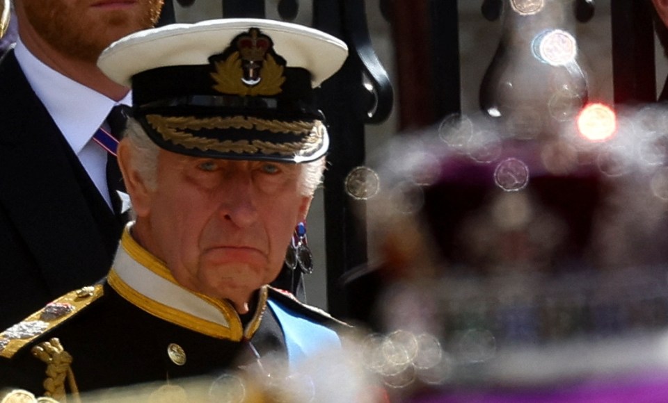 An emotional-looking King views his mother's coffin at Westminster Abbey