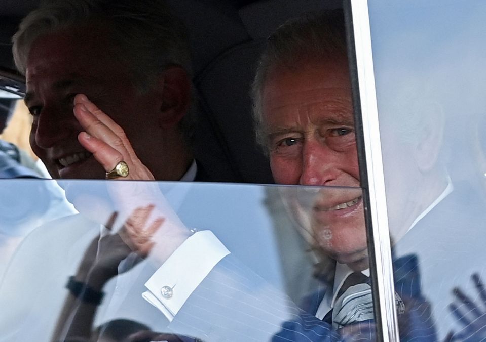 King Charles waves at well-wishers as he heads  to Buckingham Palace