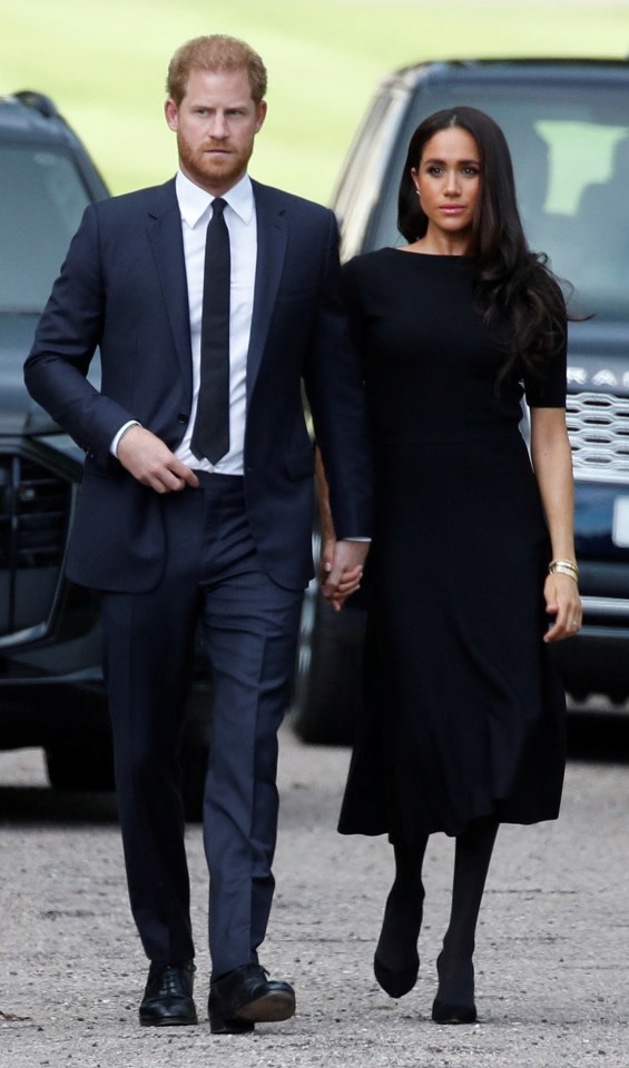 Harry held his wife's hand as they walked through Windsor