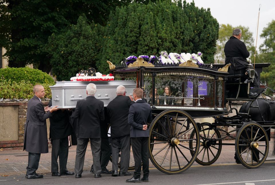 Archie's coffin is loaded onto a horse-drawn carriage for his final journey