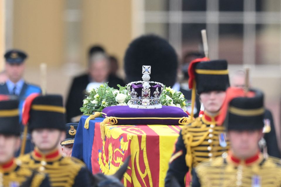 The Queen's coffin features an Imperial State Crown and white flower wreath