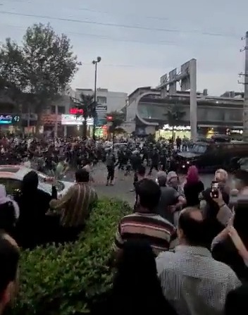 Footage shows protesters forcing back a police truck in the city of Amol