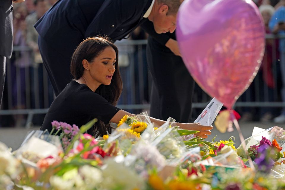 The Duchess of Sussex views flowers and messages left by members of the public