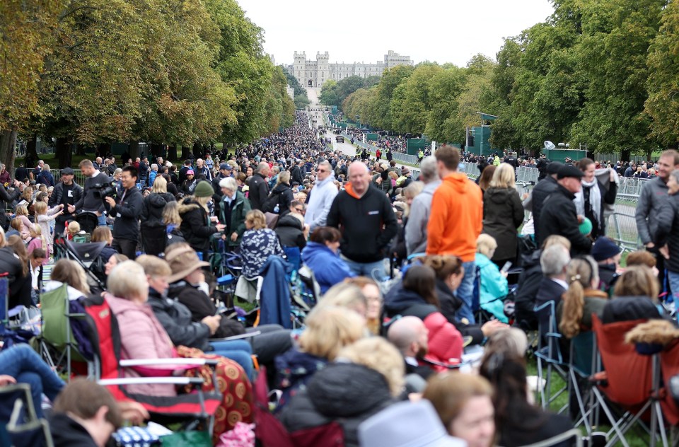 Huge crowds of people are lined up on the long walk up to Windsor Castle