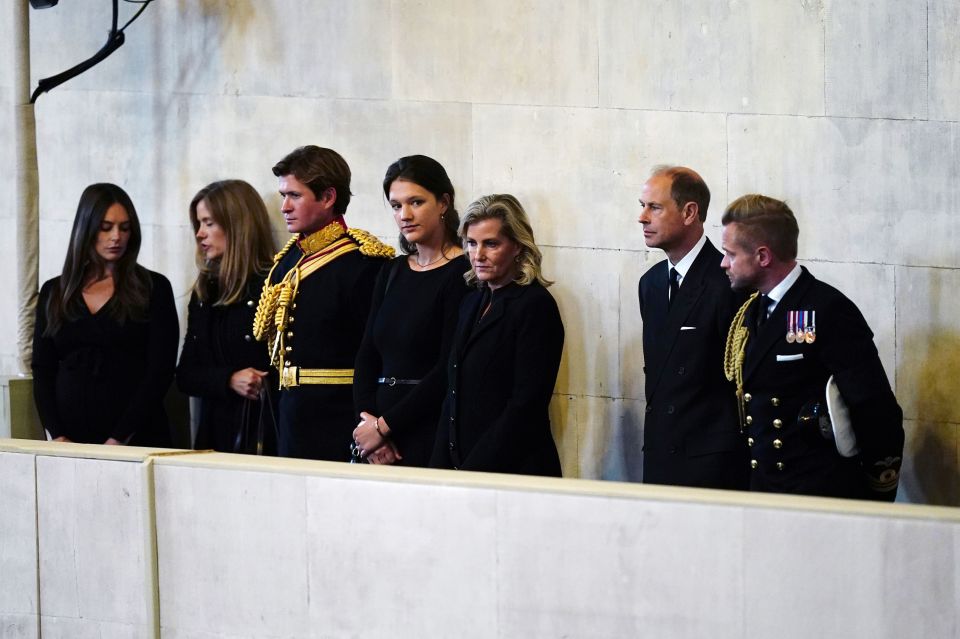 A solemn Earl and Countess of Wessex watch son James, Viscount Severn