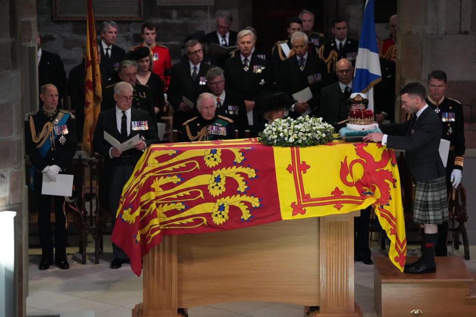 The Duke of Hamilton places the Crown of Scotland on the coffin during the Service of Prayer and Reflection for the Life of Queen