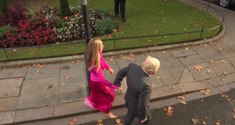 They held hands again to walk towards a Range Rover to leave Downing Street for the final time