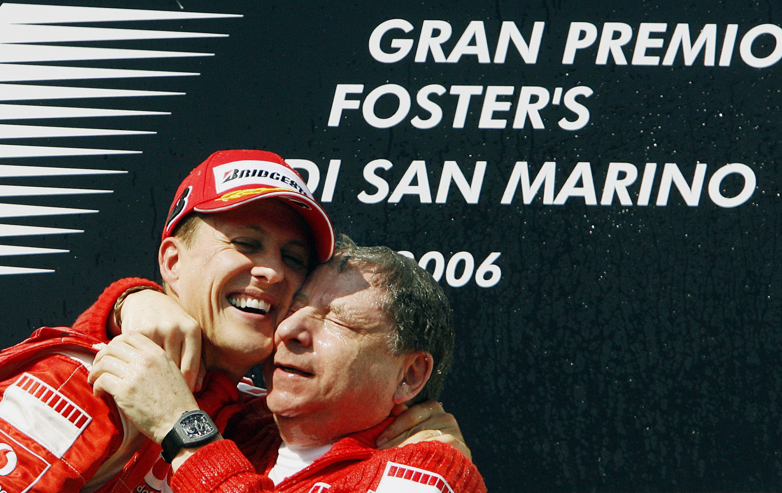 Michael Schumacher celebrates with Jean Todt on the podium in 2006