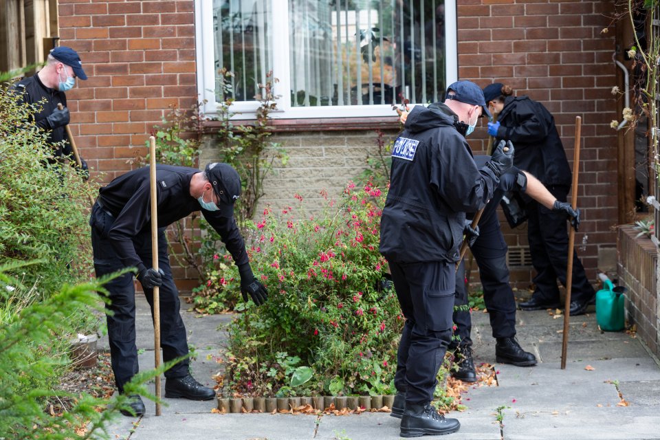 Forensic officers search a front garden near to where the teen was stabbed