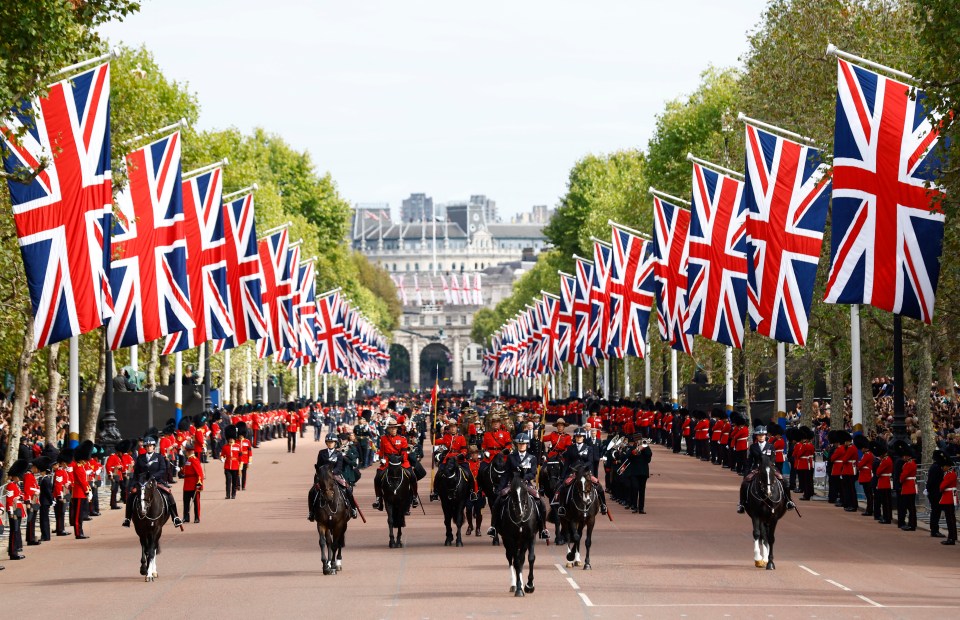 The funeral procession marches down The Mall following the service at Westminster Abbey