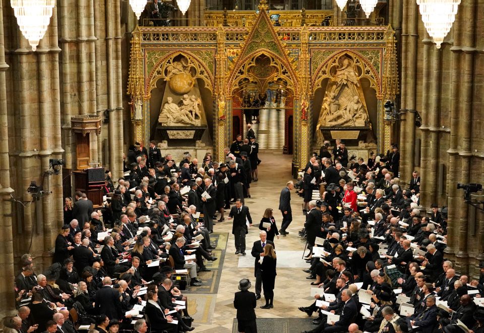 Guests and officials begin to take their places in Westminster Abbey