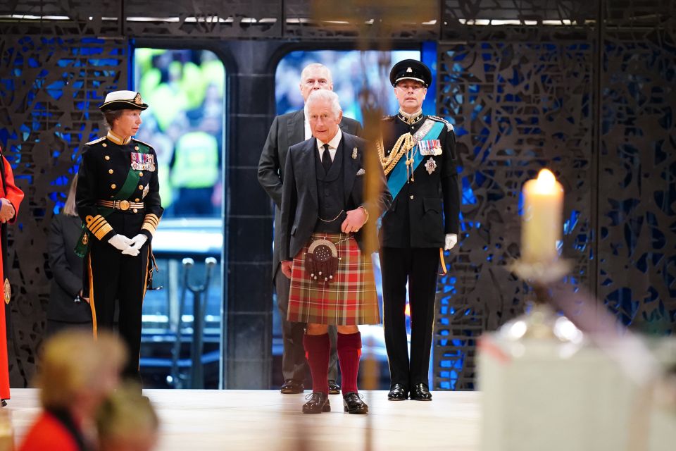 Charles stood silently as mourners fought back tears