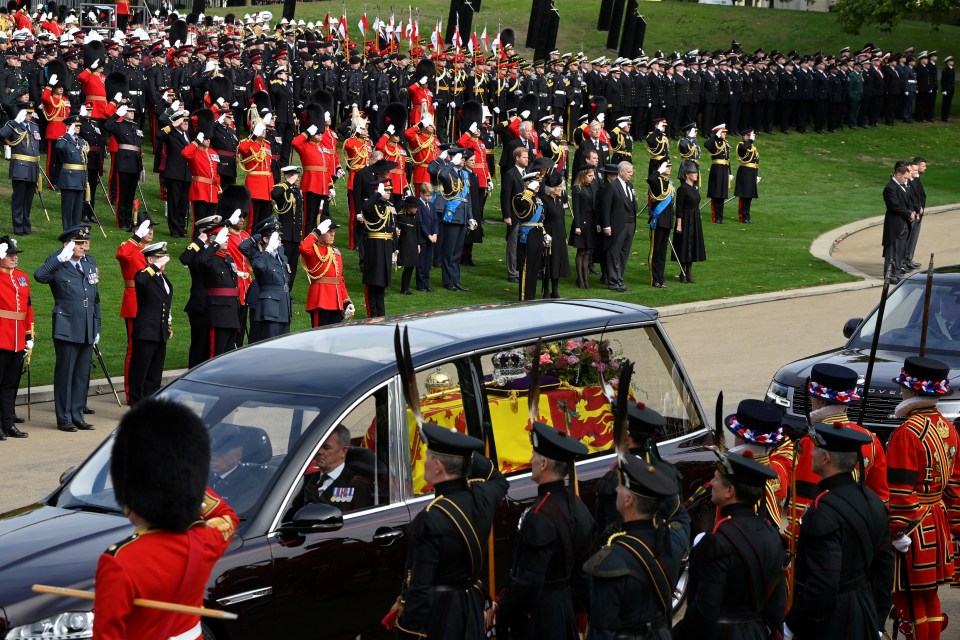 Members of the Royal Family and military salute as the hearse drove off to Windsor from Wellington Arch