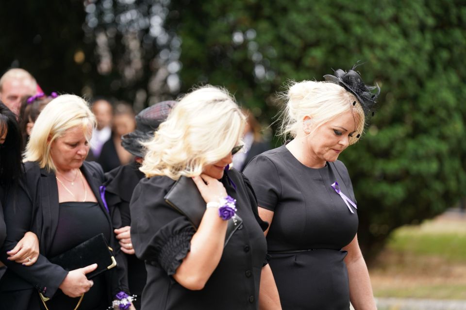 Mum Hollie Dance, right, leads mourners behind her son's coffin as she enters the church