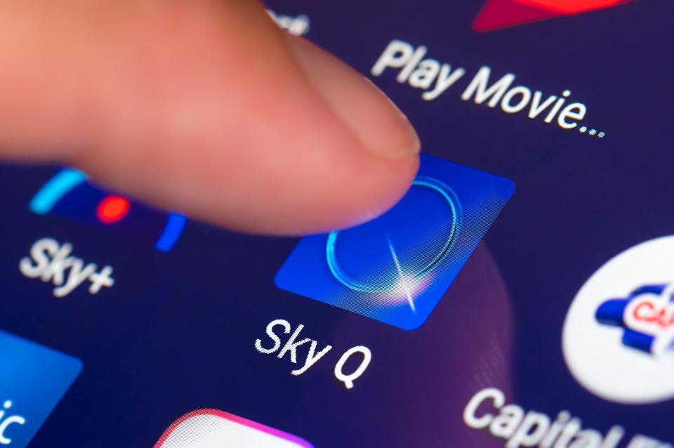 Finger pressing Sky Q app icon on a mobile device.