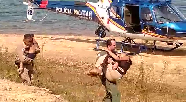 Police officers carry Ludmila and Kyara to a helicopter three days after they got lost