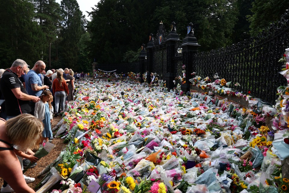 Mourners lay flowers outside the Sandringham Estate following the Queen’s death