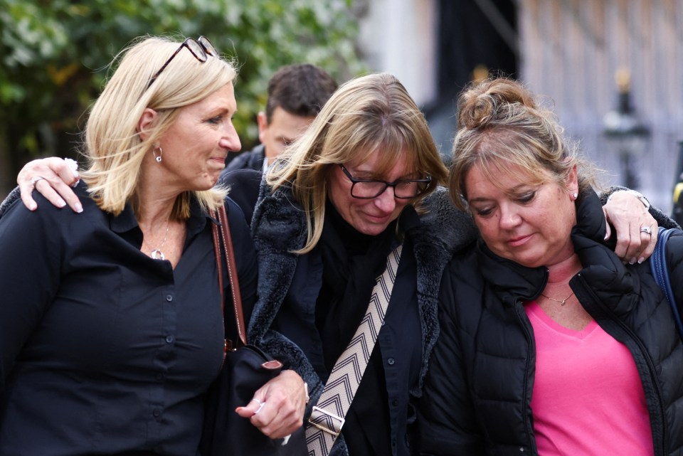 Mourners filing past weep as they leave Westminster Hall