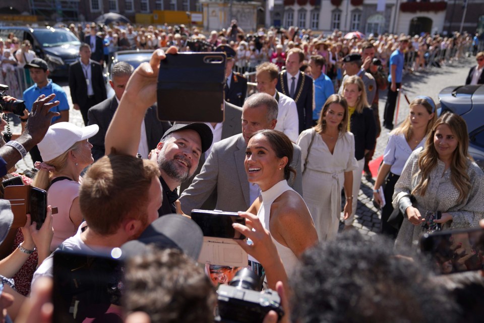 The Duchess of Sussex posing for selfies with German fans