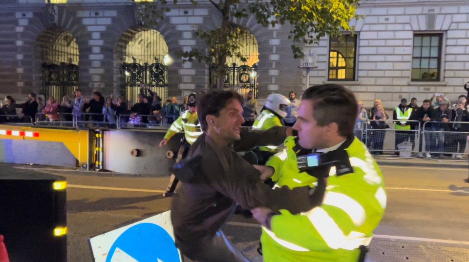 The car carrying King Charles III drove past under armed police escort seconds later