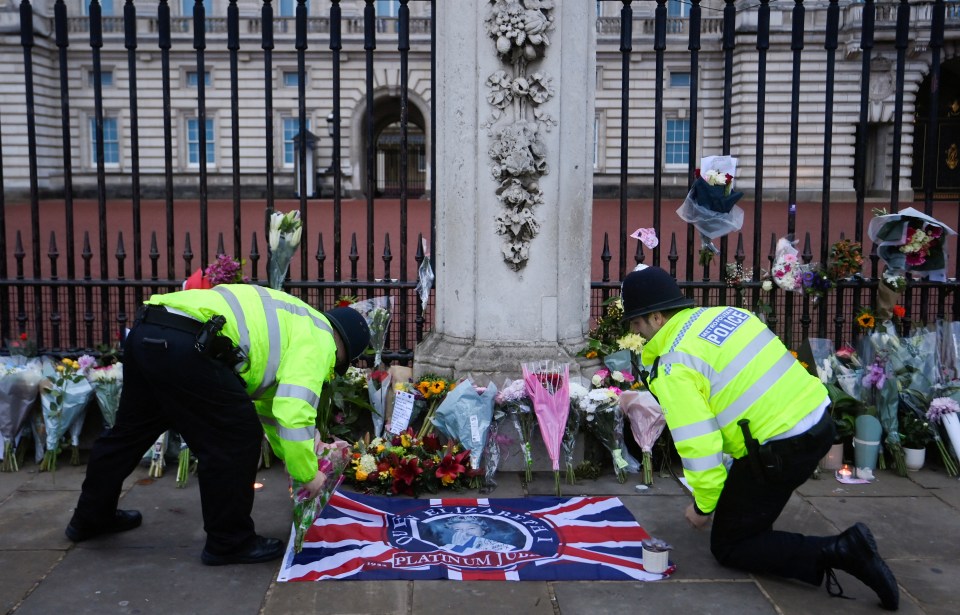 Mourners have laid items like flags and flowers in memory of the beloved monarch