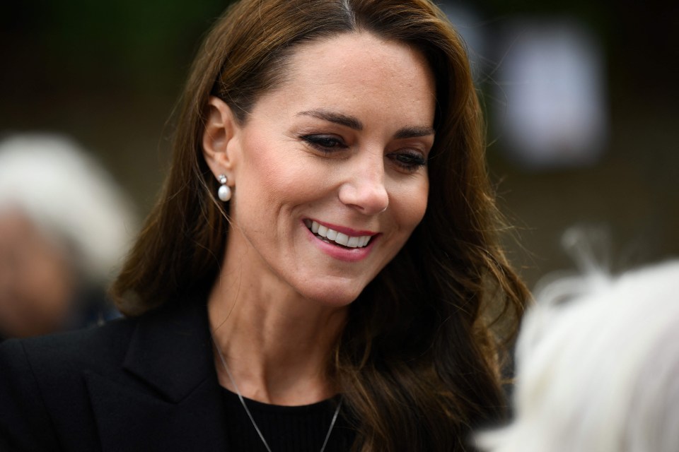 Kate smiles as she chats to mourners at Sandringham